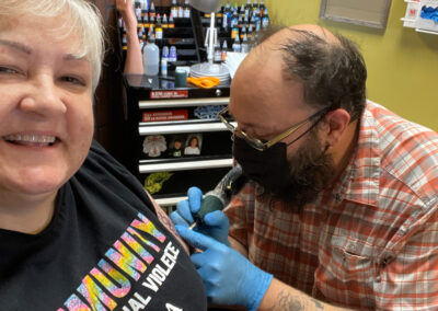 Sandra Williams, MOCSA's Event Coordinator, receiving a tattoo at Glory Bound Tattoo.