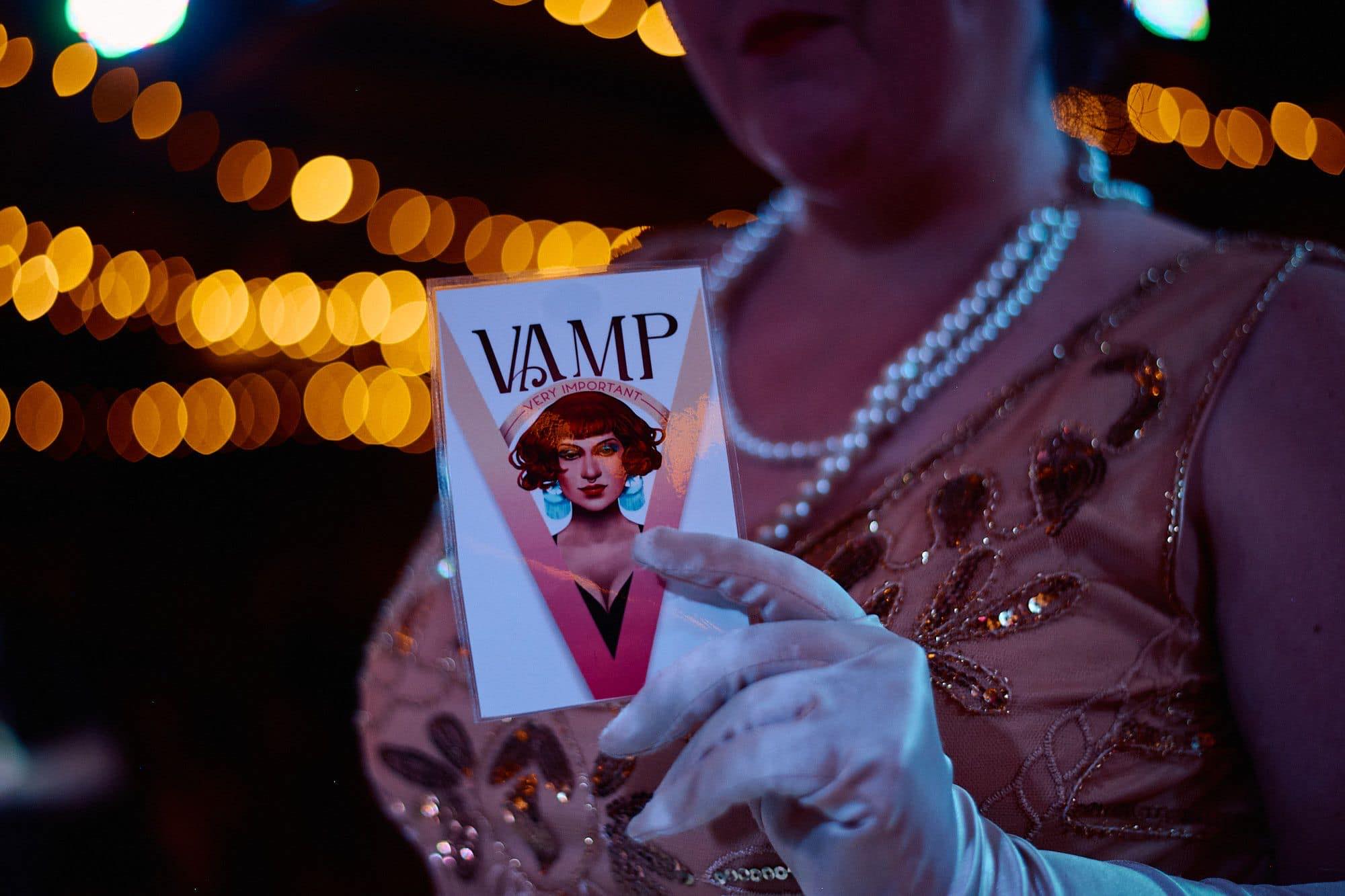 Woman holding a flyer that says VAMP very important