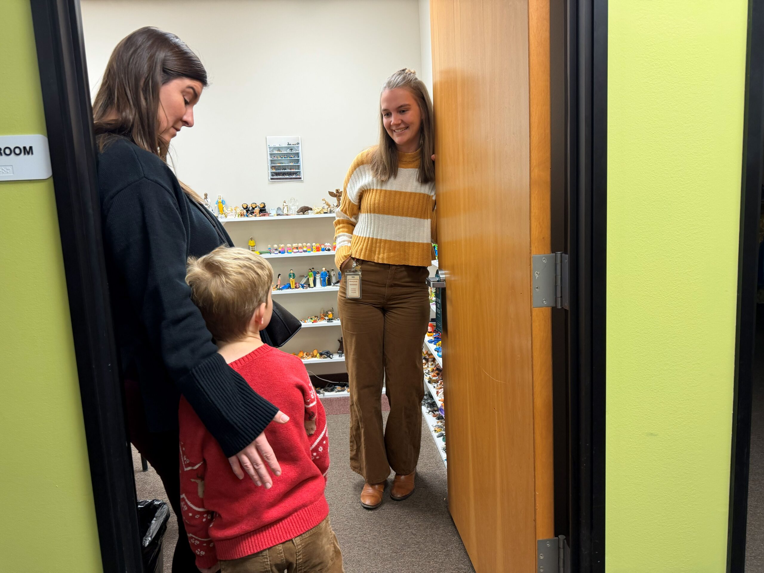 Child and woman are greeted by MOCSA Therapist at the entrance of the Sand Tray Therapy room
